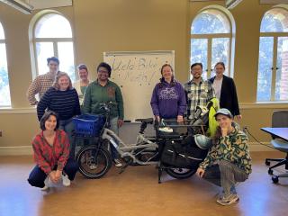 Faculty member and grad students in a classroom 